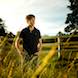 Senior Pictures: Senior posing in front of fence